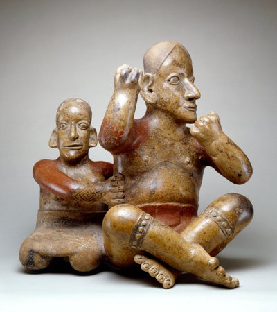 Seated male and female by Colima Culture